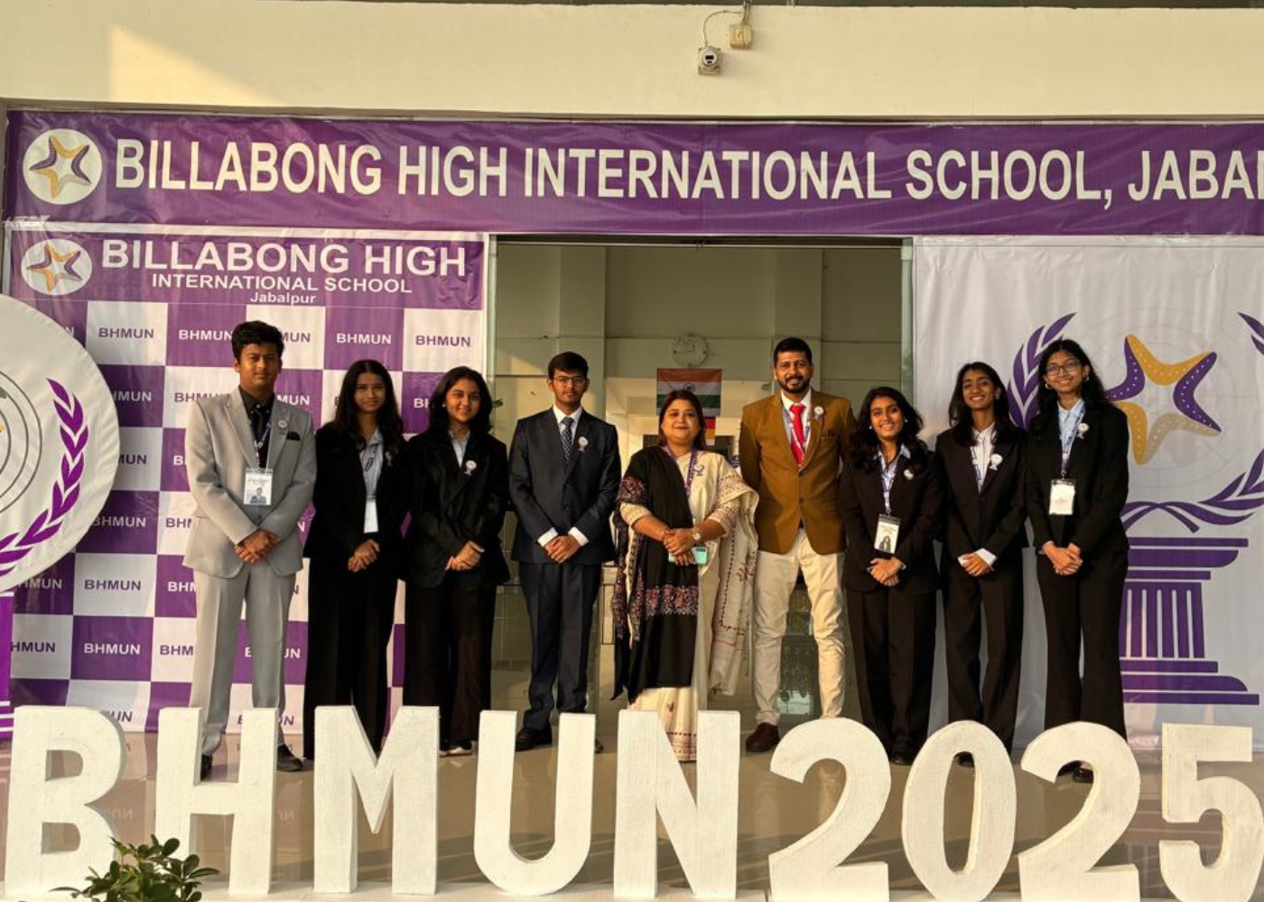 Students in school uniforms posing in corridor